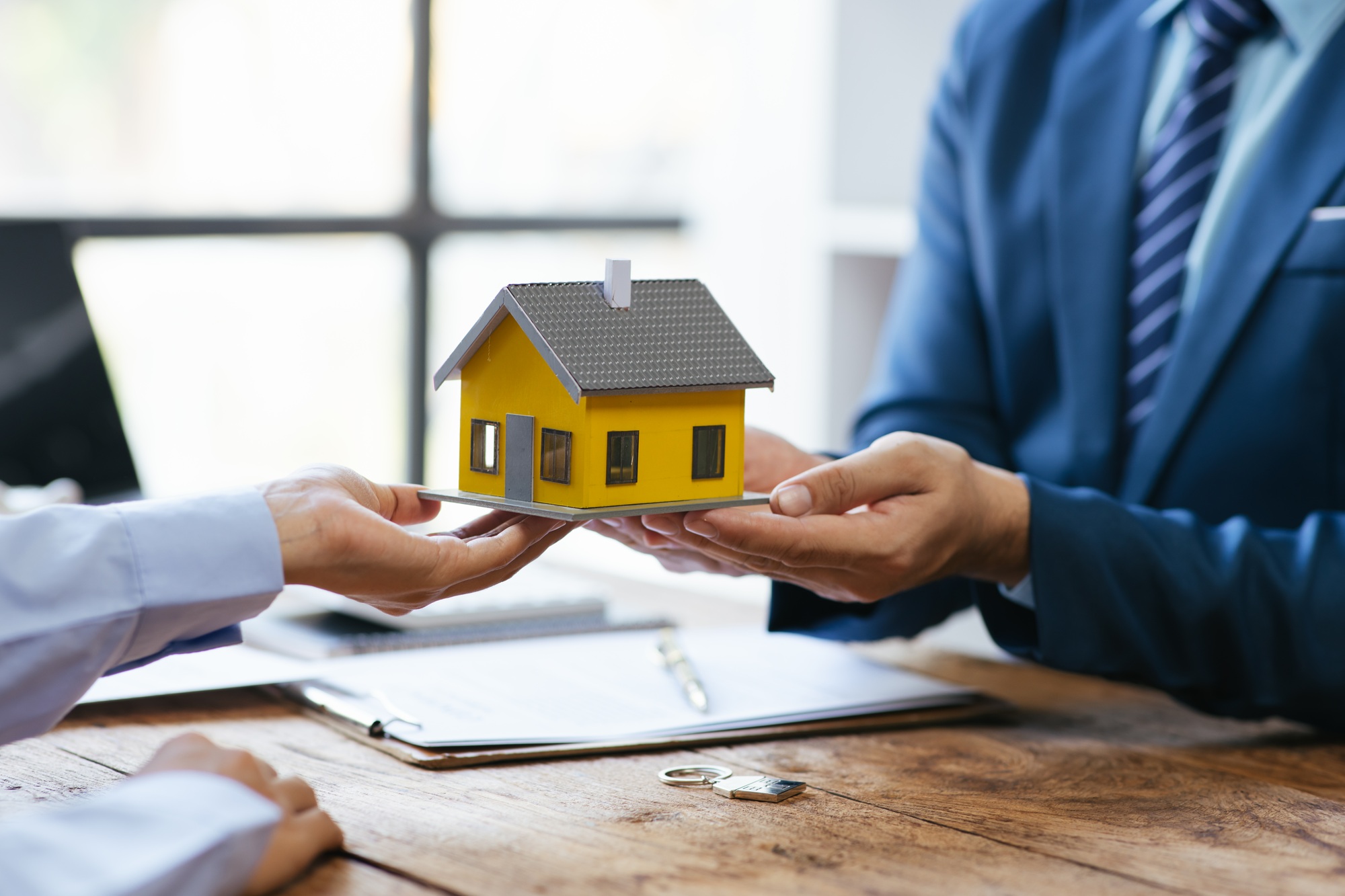 Close up Business people or Real Estate agent explain signing agreement for sale house to client. P